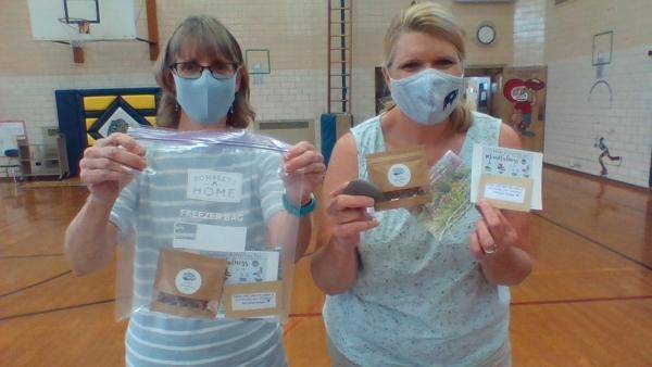 Edison Elementary staff pose with take-home garden kits
