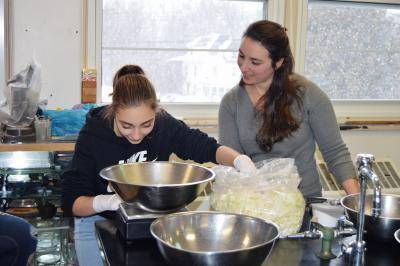 Photo of two people weighing cabbage for sauerkraut